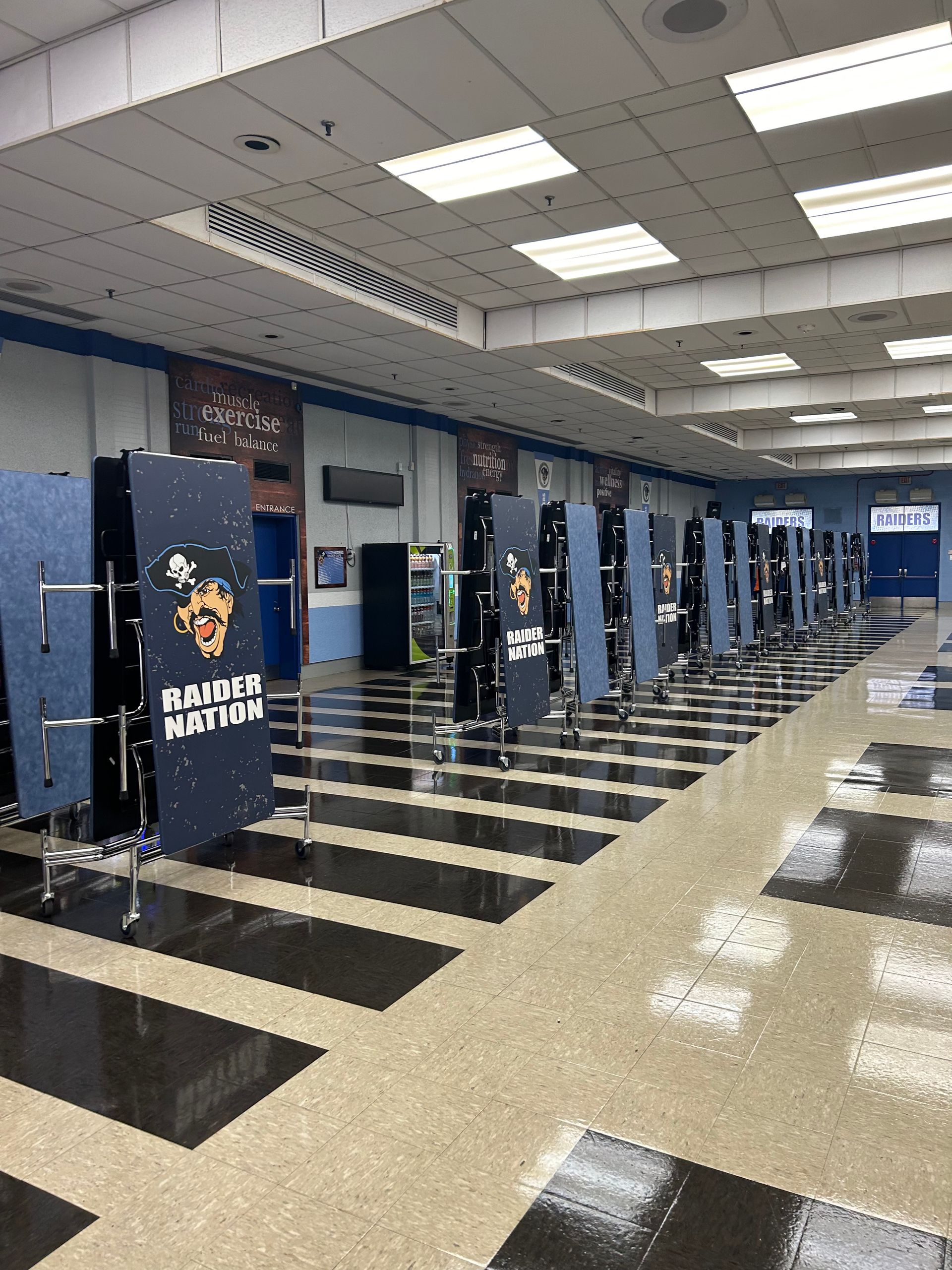 A large room with a lot of tables and chairs in it.