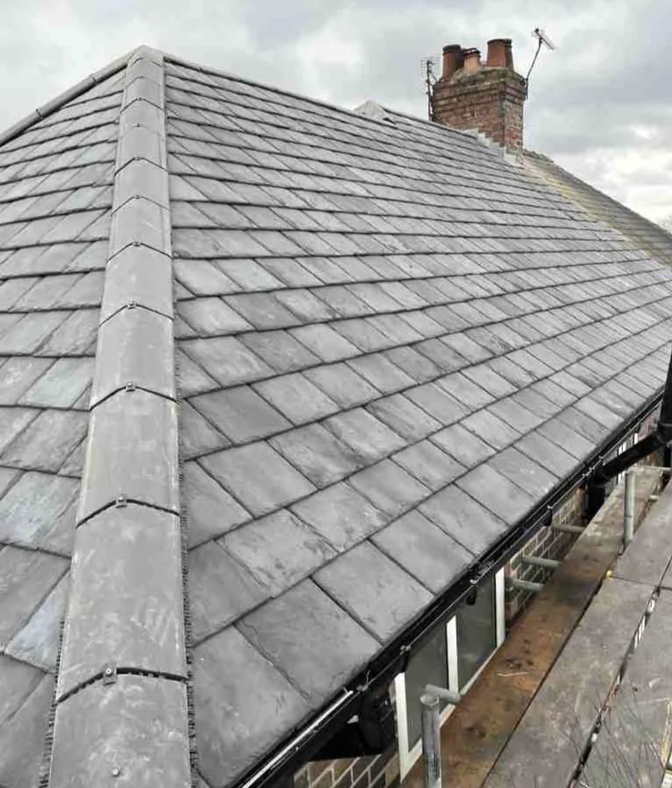 A close up of a roof with a chimney on top of it.