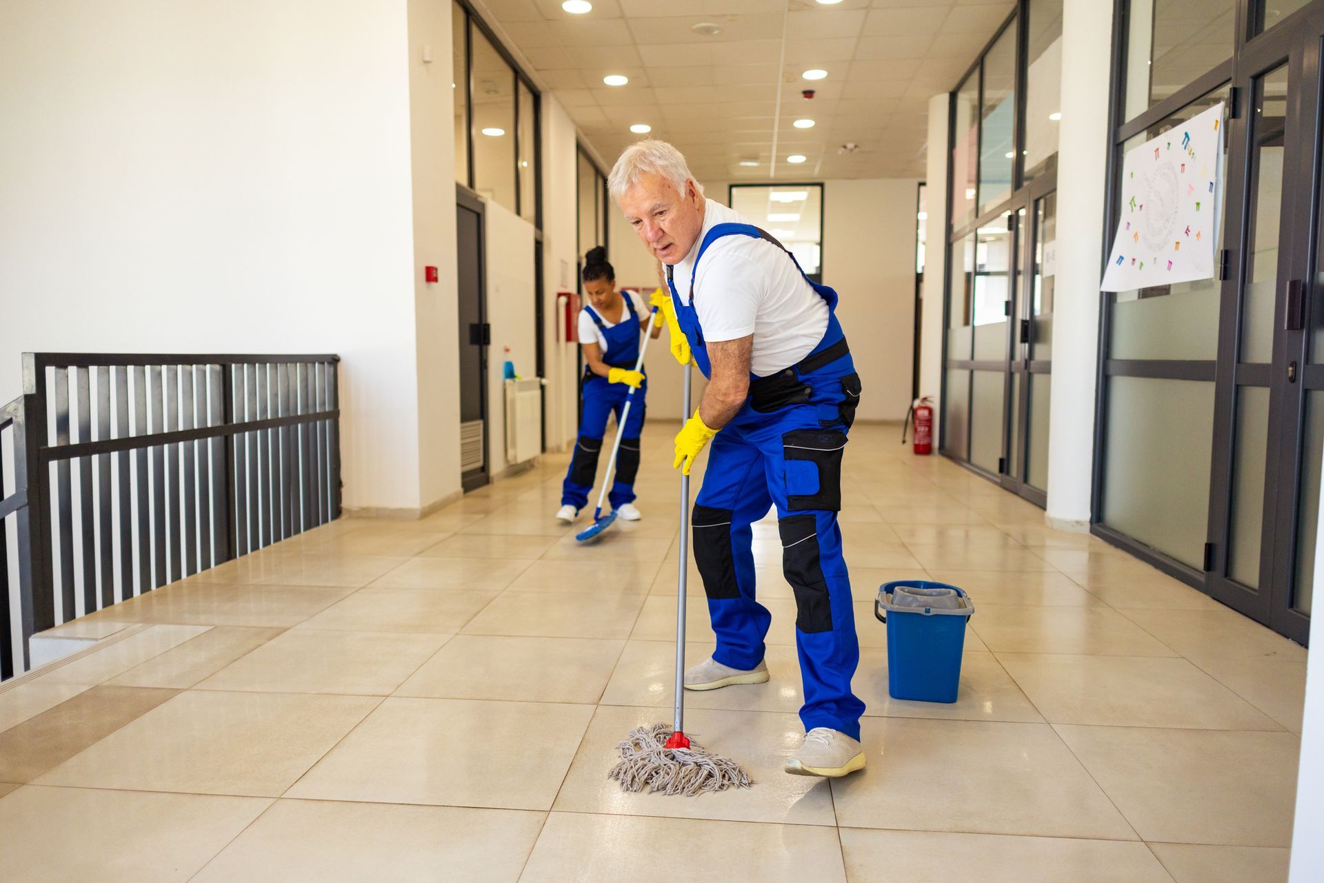 Janitors cleaning the floor in elementary school building. Janitors cleaning the floor in elementary school building.