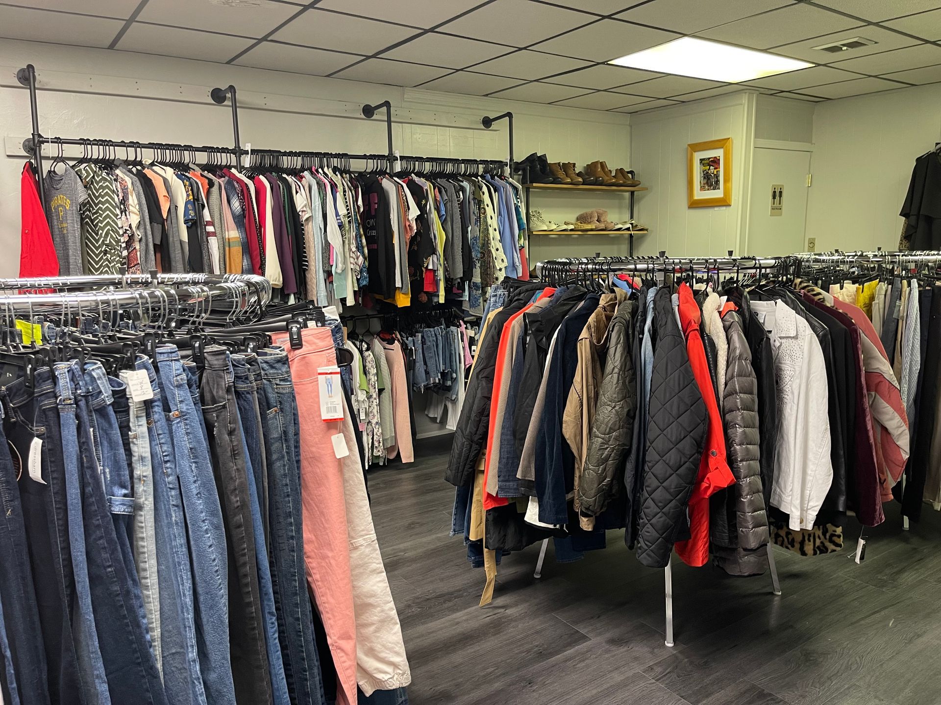 A store filled with lots of clothes hanging on racks.