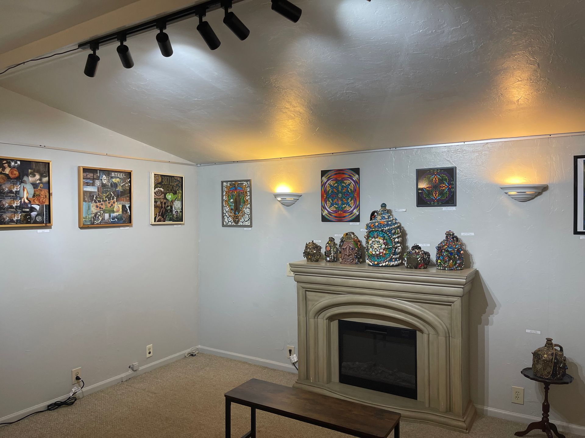 A shelf with paintings on it is sitting next to a wall.