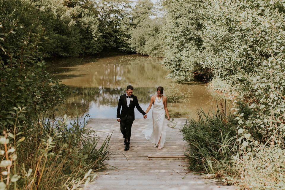 Bride and groom holding hands and walking