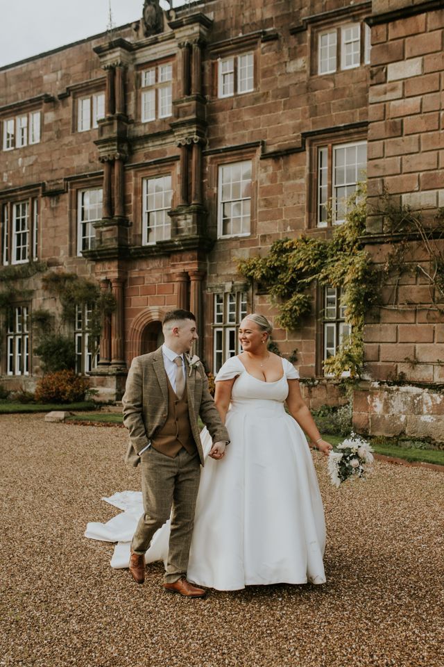 bride and groom walking holding hands outside bowsholme hall cltheroe
