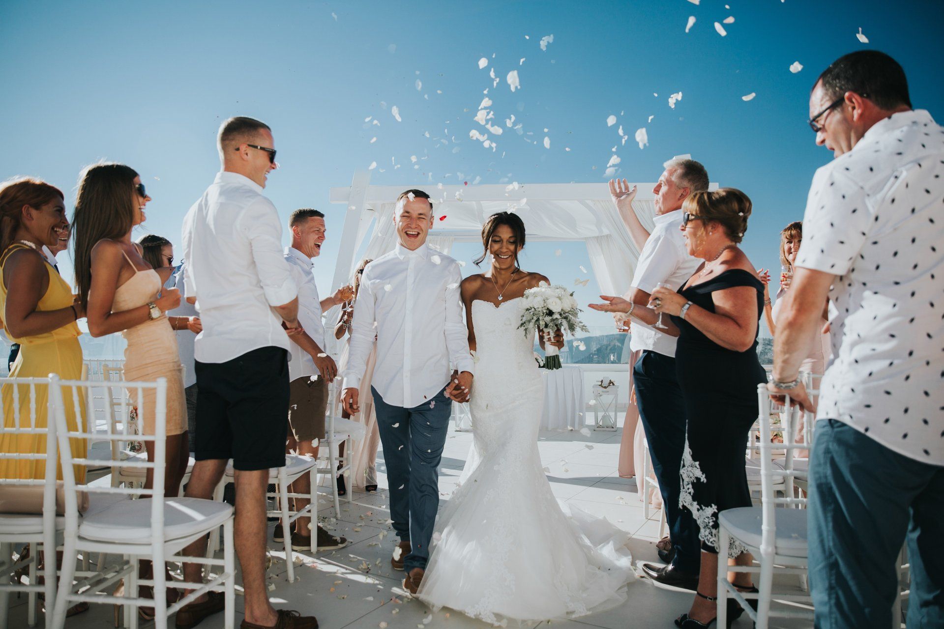 wedding photograph bride and Groom confetti shot at destination wedding in Santorini
