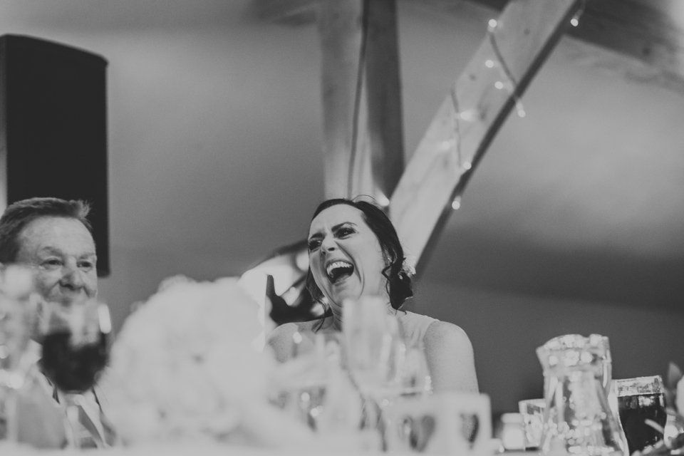 wedding guest sat at table laughing at the speeches