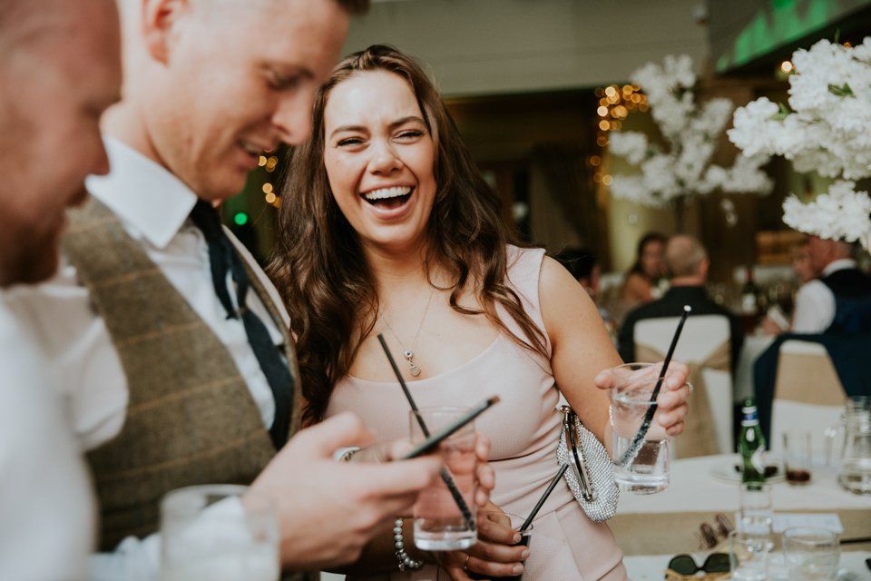 wedding guest laughing at wedding reception
