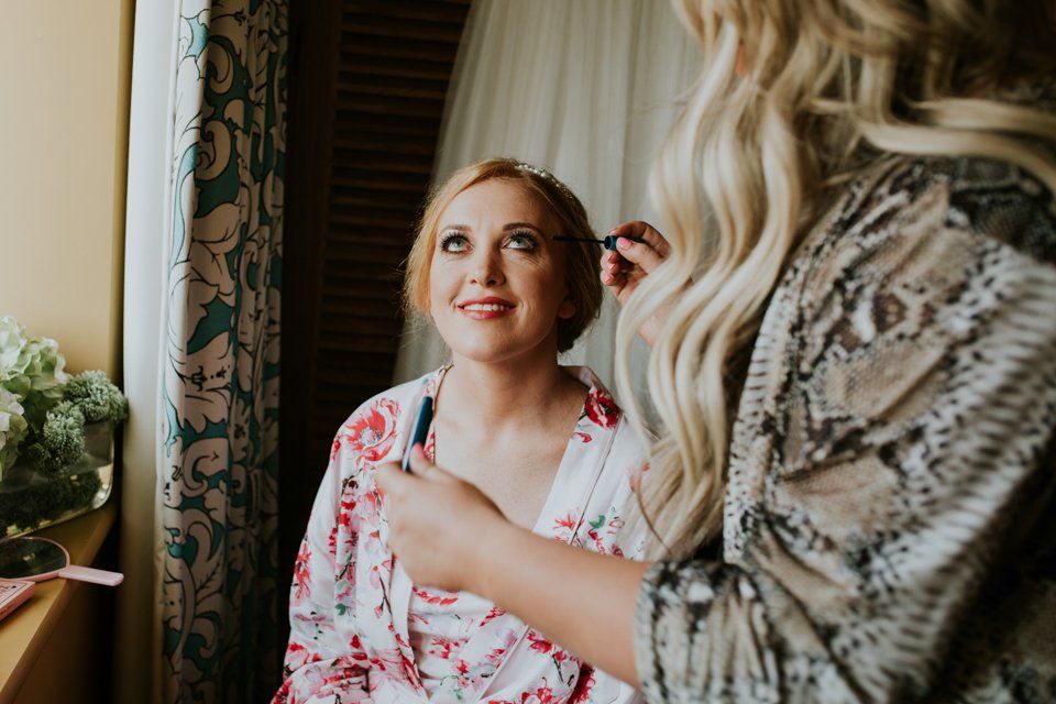 bride having her make up done before her wedding