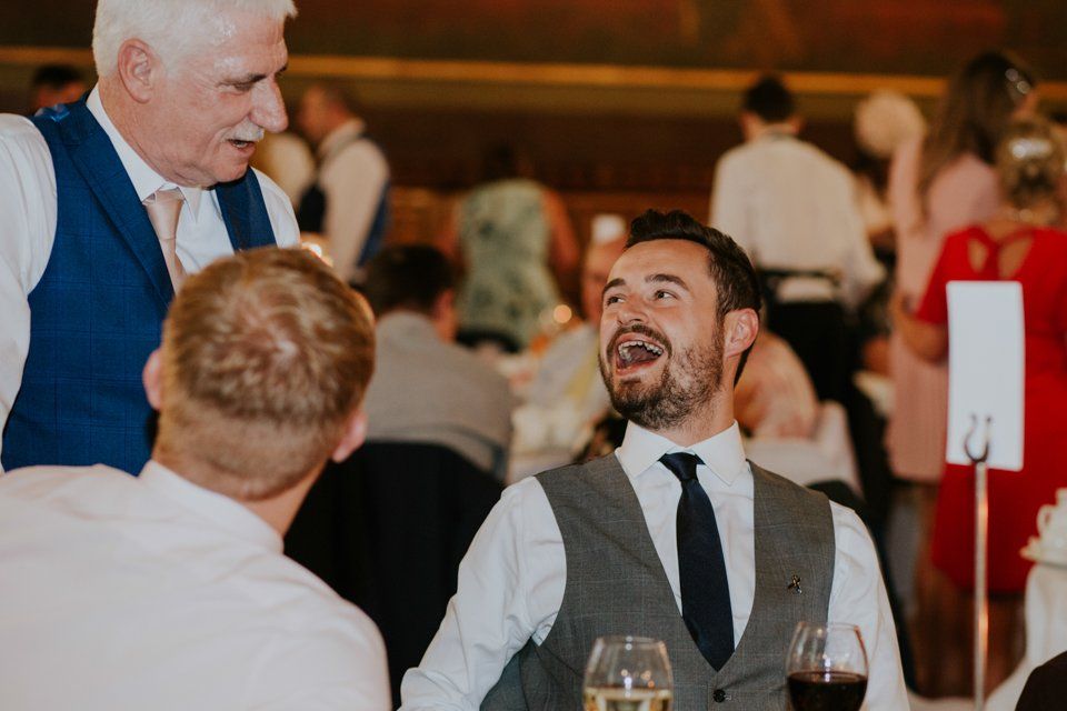 wedding guests talking and laughing together