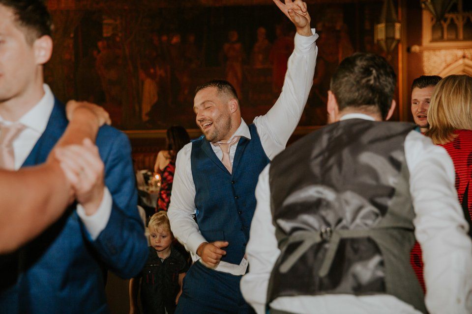 wedding guest dancing holding one hand in the air