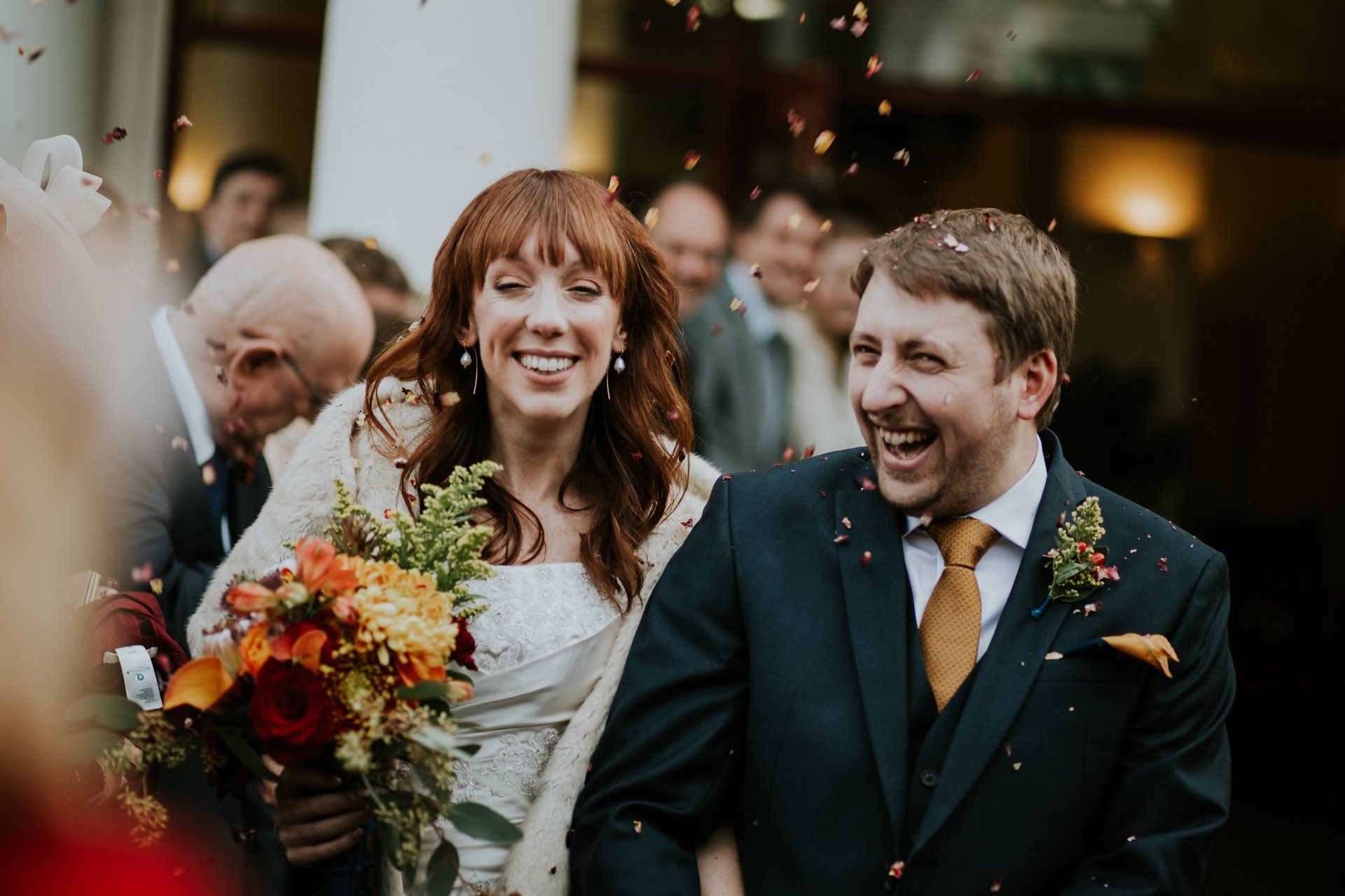 Bride and Groom leaving church wedding with confetti photograph