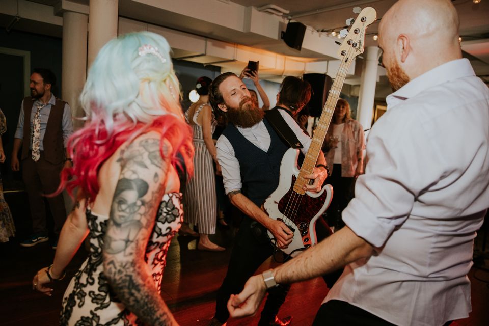 Bride and groom dancing to wedding band