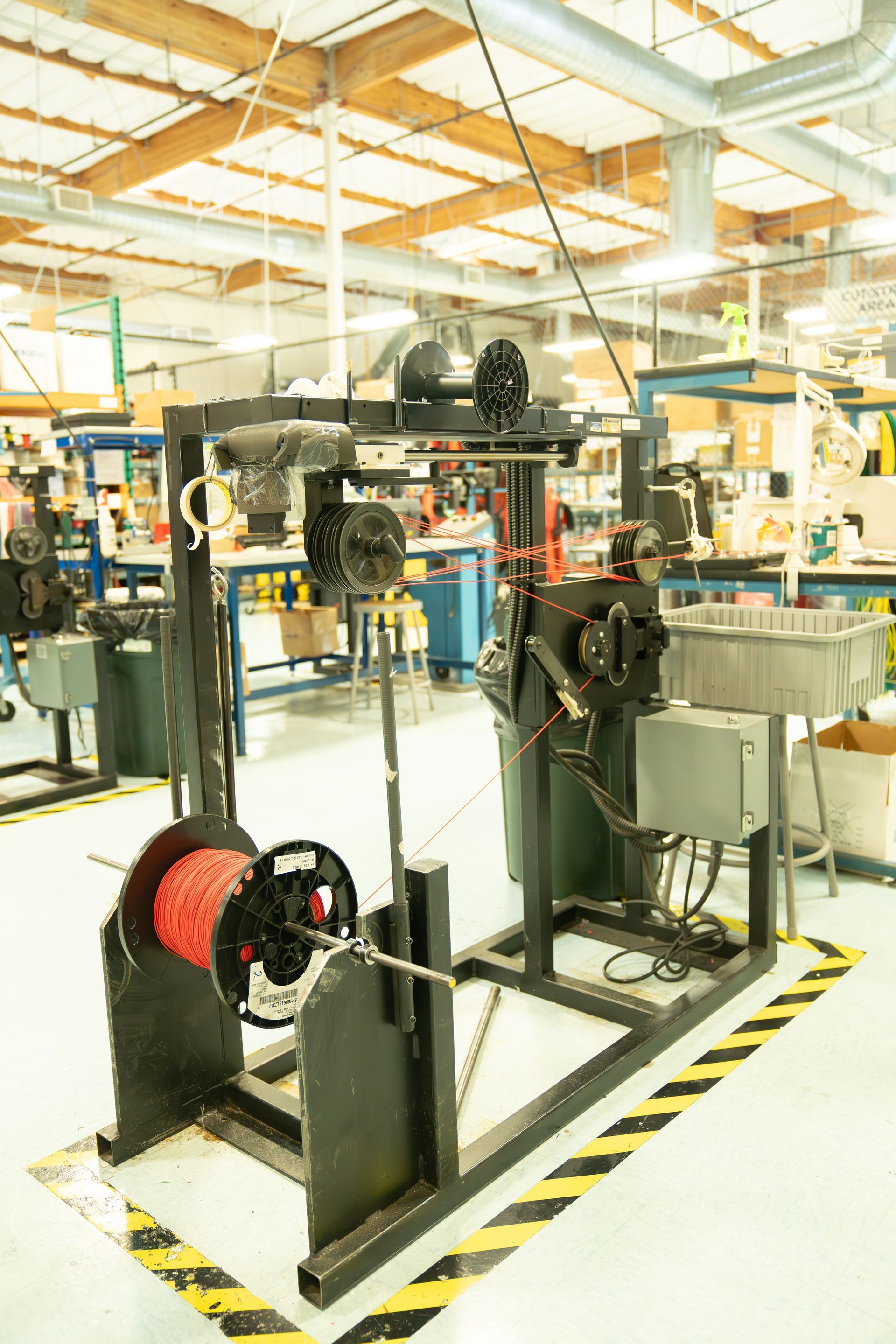 A machine is sitting in the middle of a room in a factory.