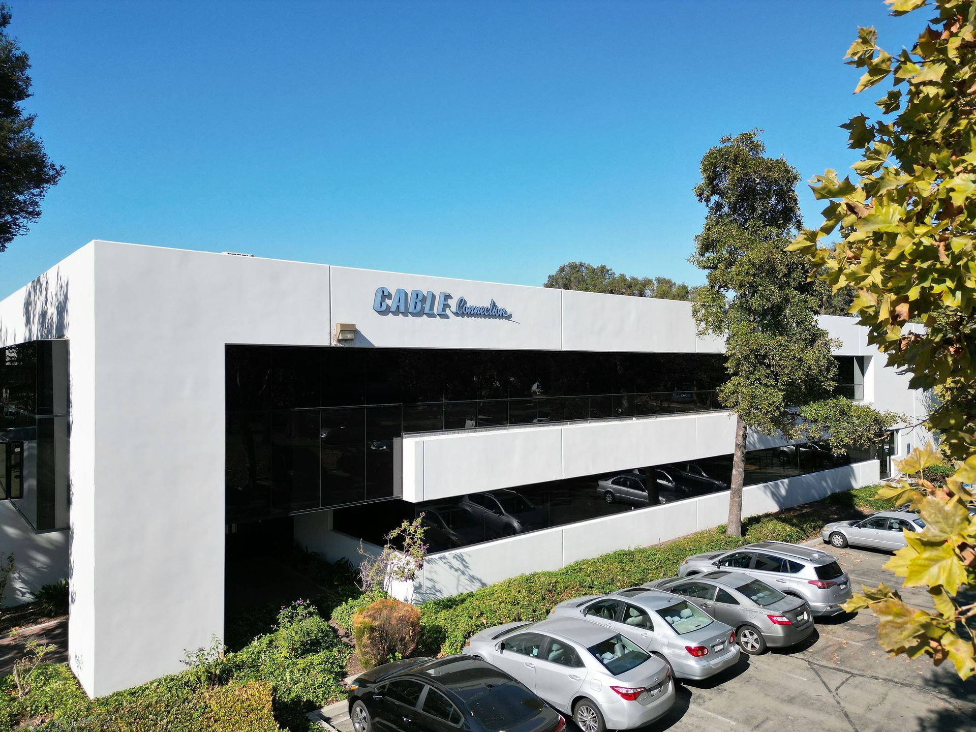 A large white building with cars parked in front of it