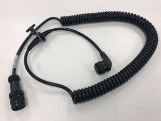 A close up of a coiled cable on a white surface.