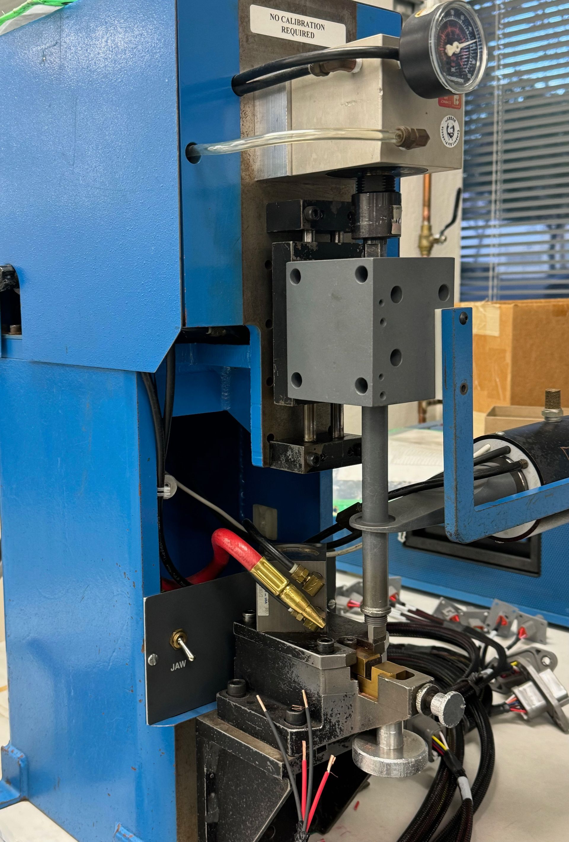 A blue machine is sitting on top of a white table.