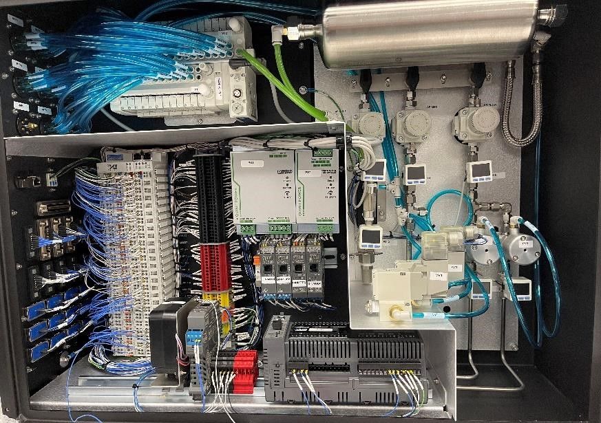The inside of a machine with a lot of wires coming out of it