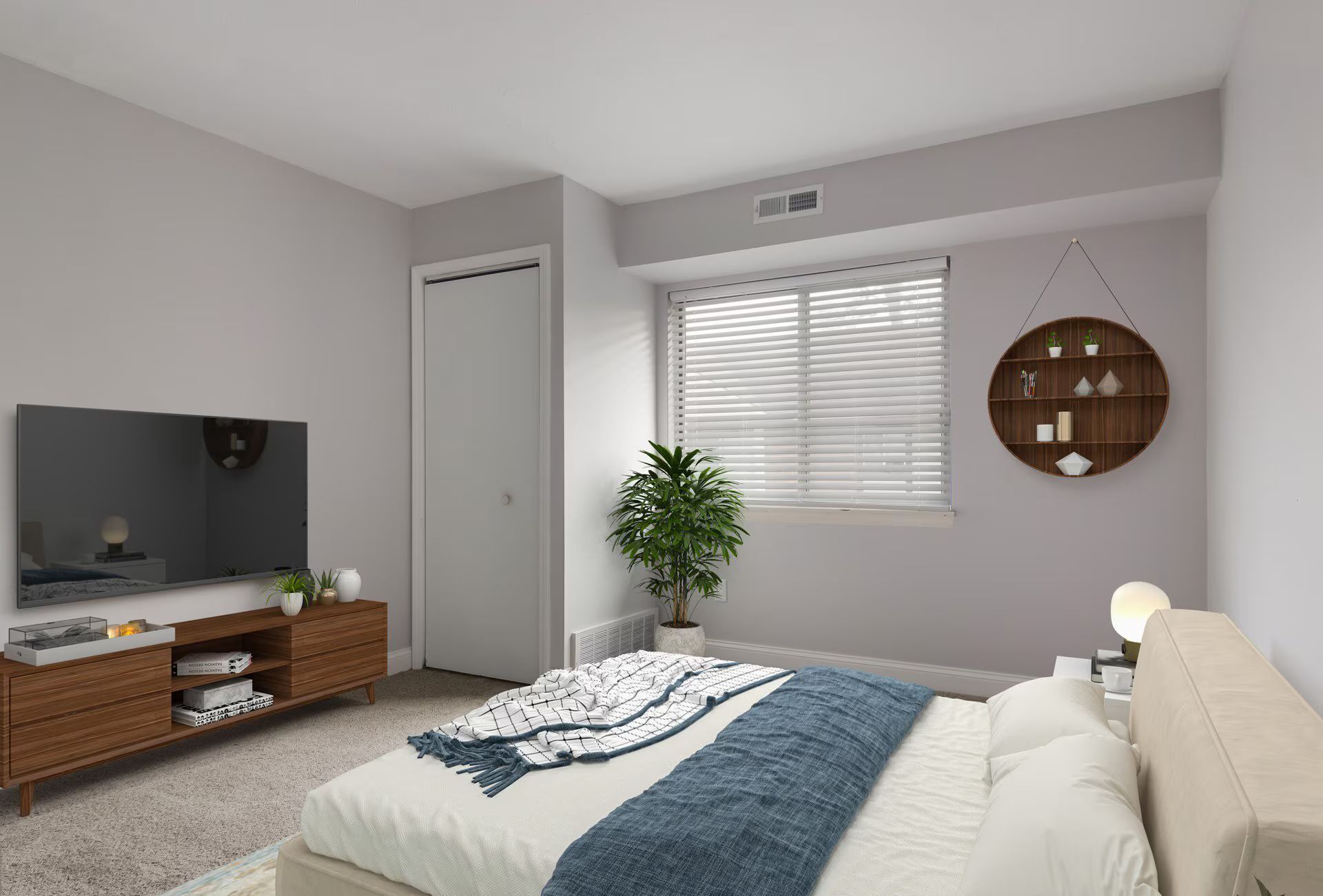 Bedroom with bed, TV, dresser, window, plant, and round shelf.