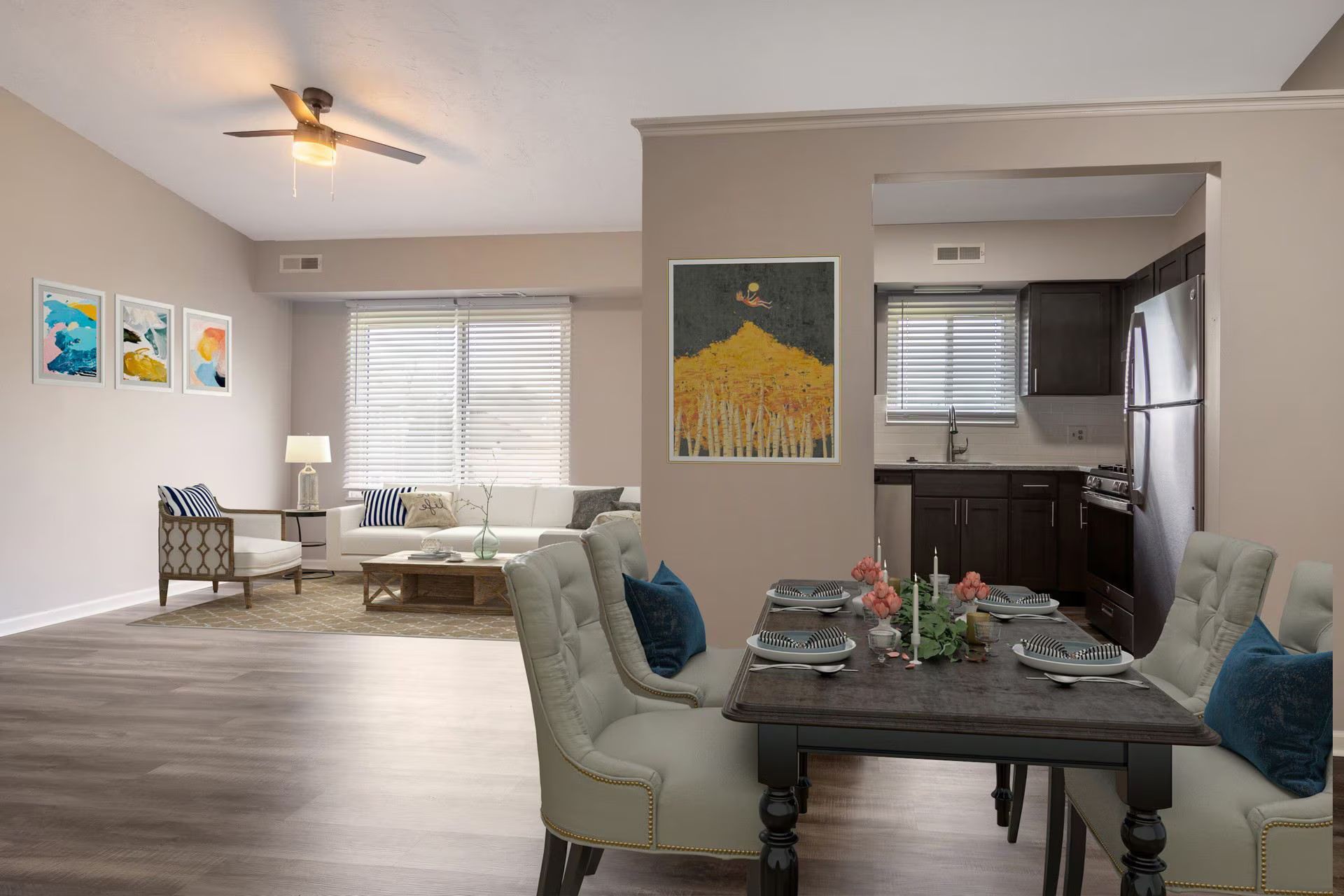Open-concept living space with dining table, kitchen, and living room visible. Neutral colors and wooden floors.