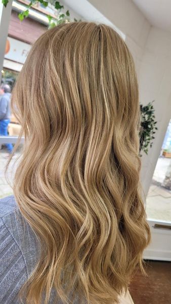 A close up of a woman 's blonde hair in a salon.