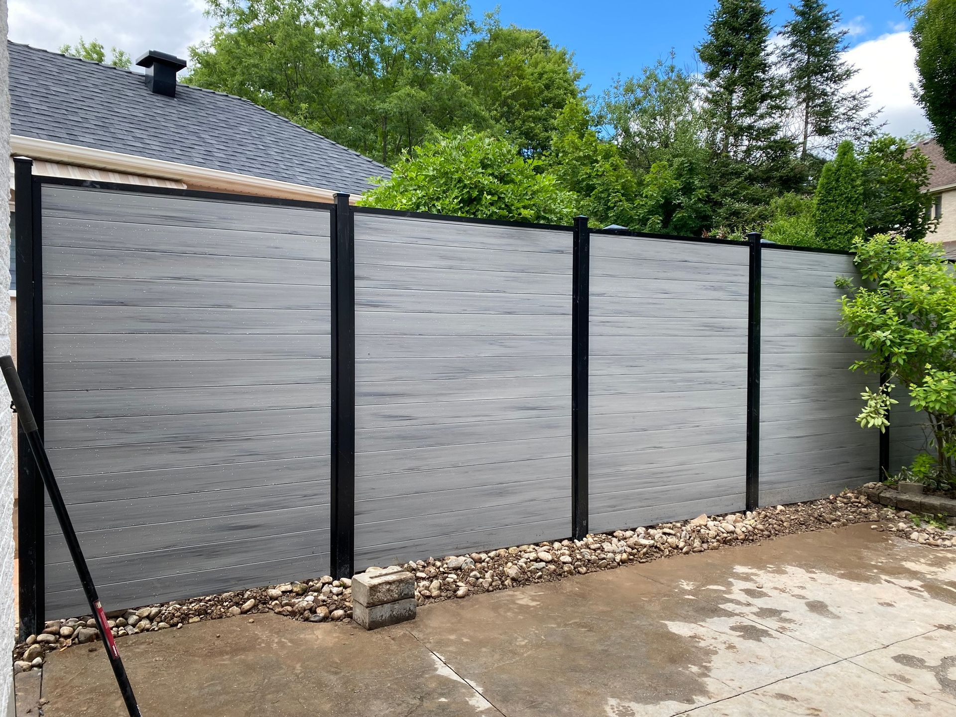 There is a fence in the backyard of a house.