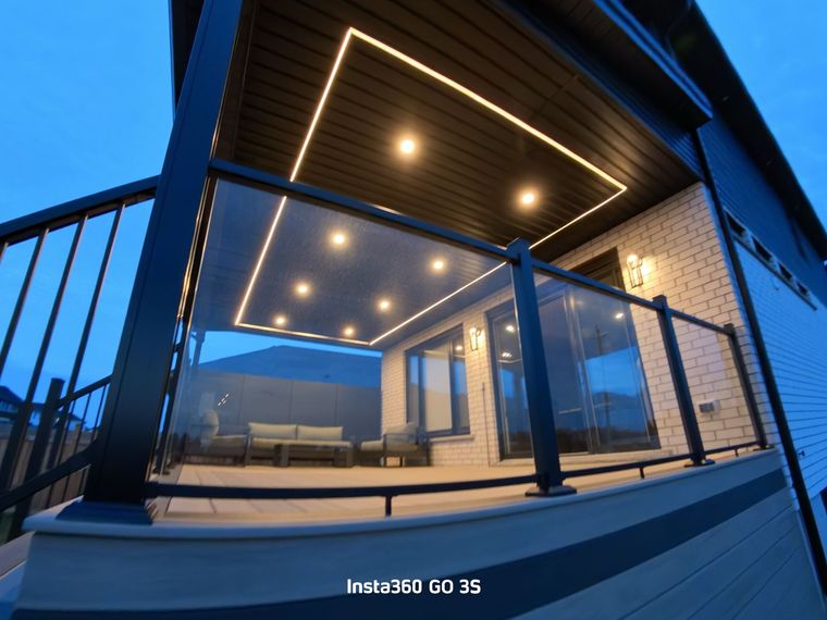 A wooden deck is being built in the backyard of a house.