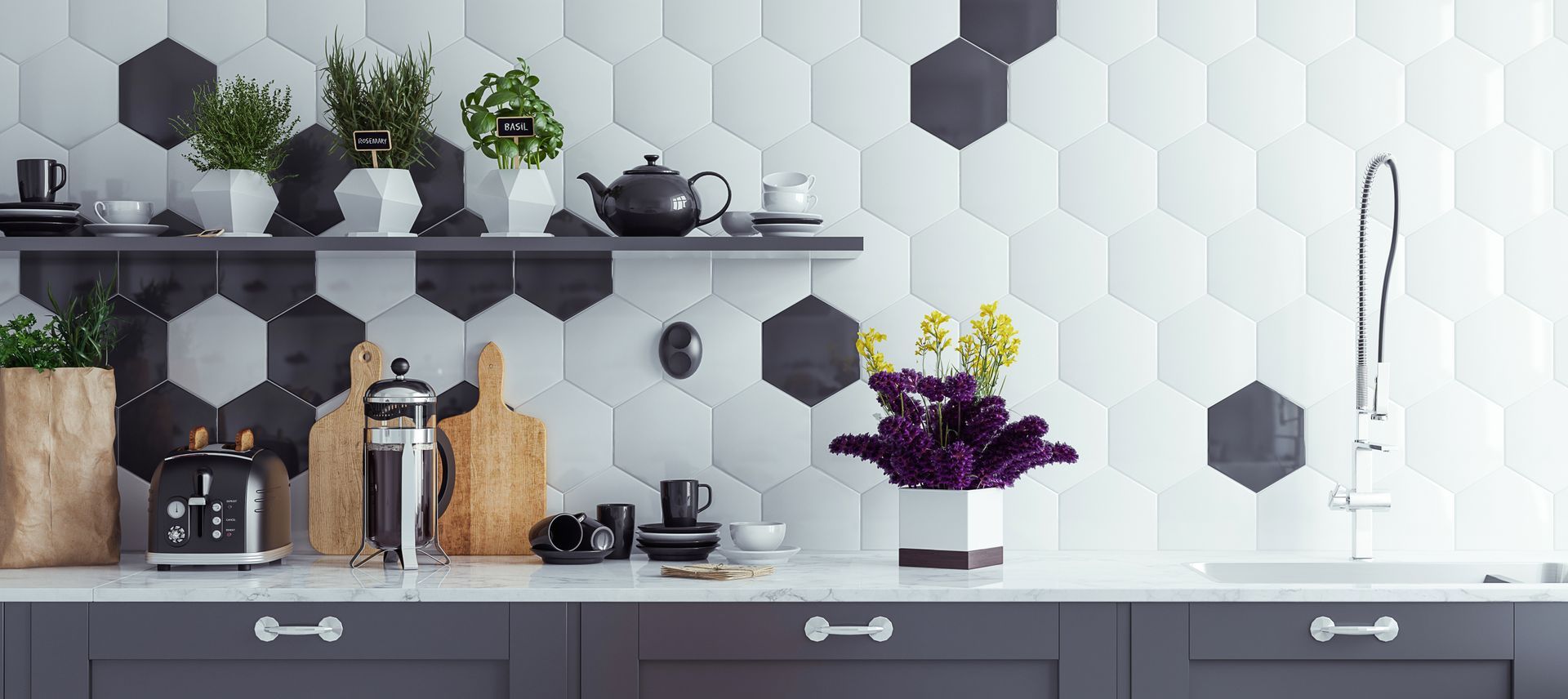 Modern kitchen shelf with potted plants, bottles, black mugs, and a purple flower vase against hexagon-tile backsplash