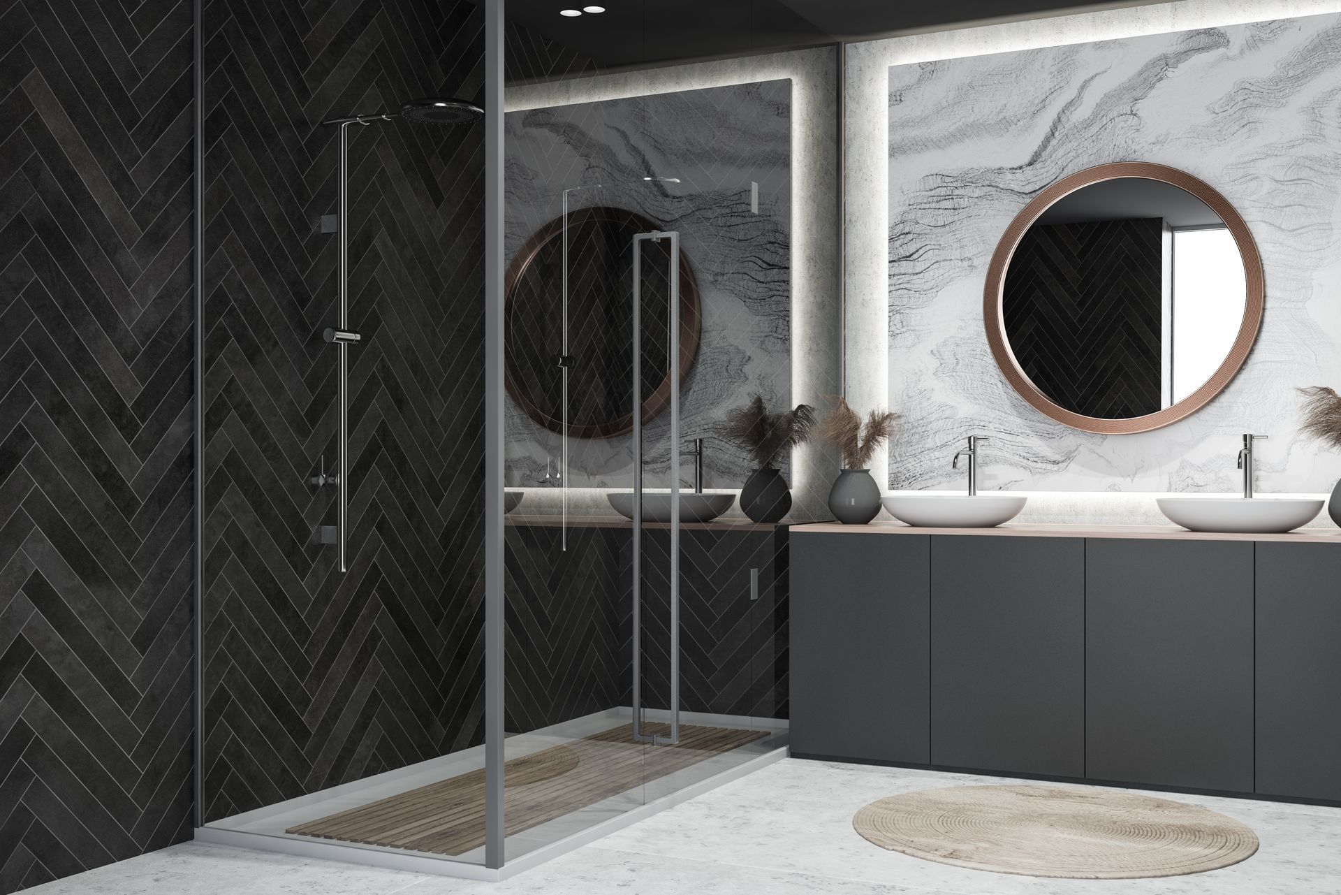 Modern bathroom with dark chevron tile, glass shower, double vanity, and round mirror above a rug.