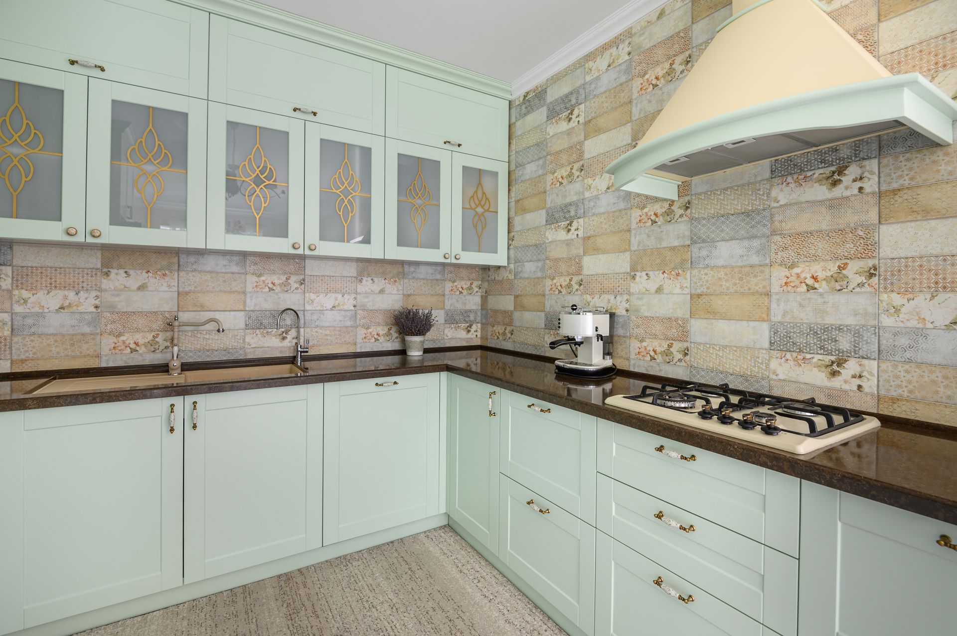 Bright modern kitchen with white cabinets, stone tile backsplash, and black countertop