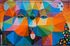 A colorful painting of a bear 's face on a brick wall.