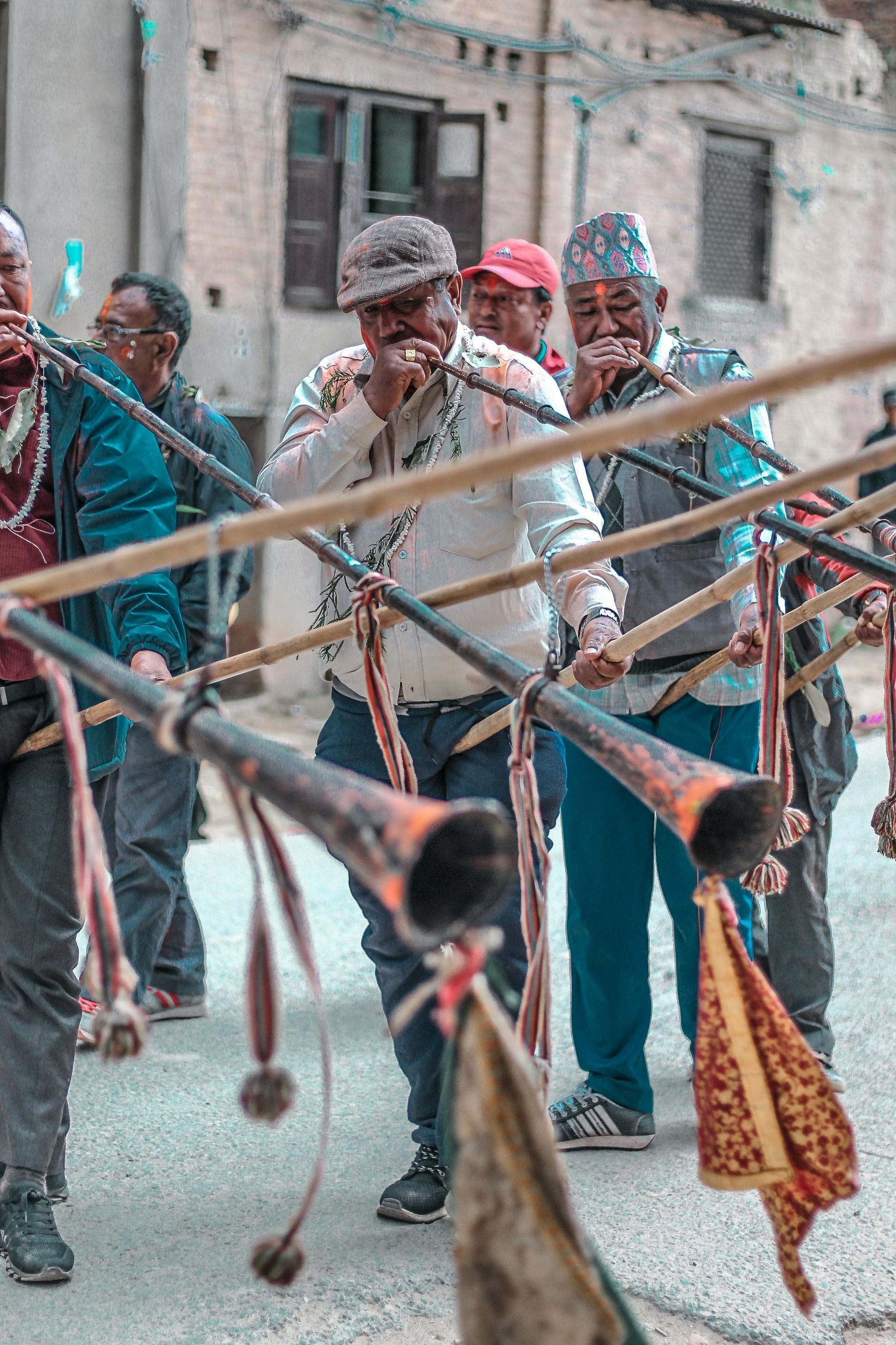 A group of men are playing instruments on a street.