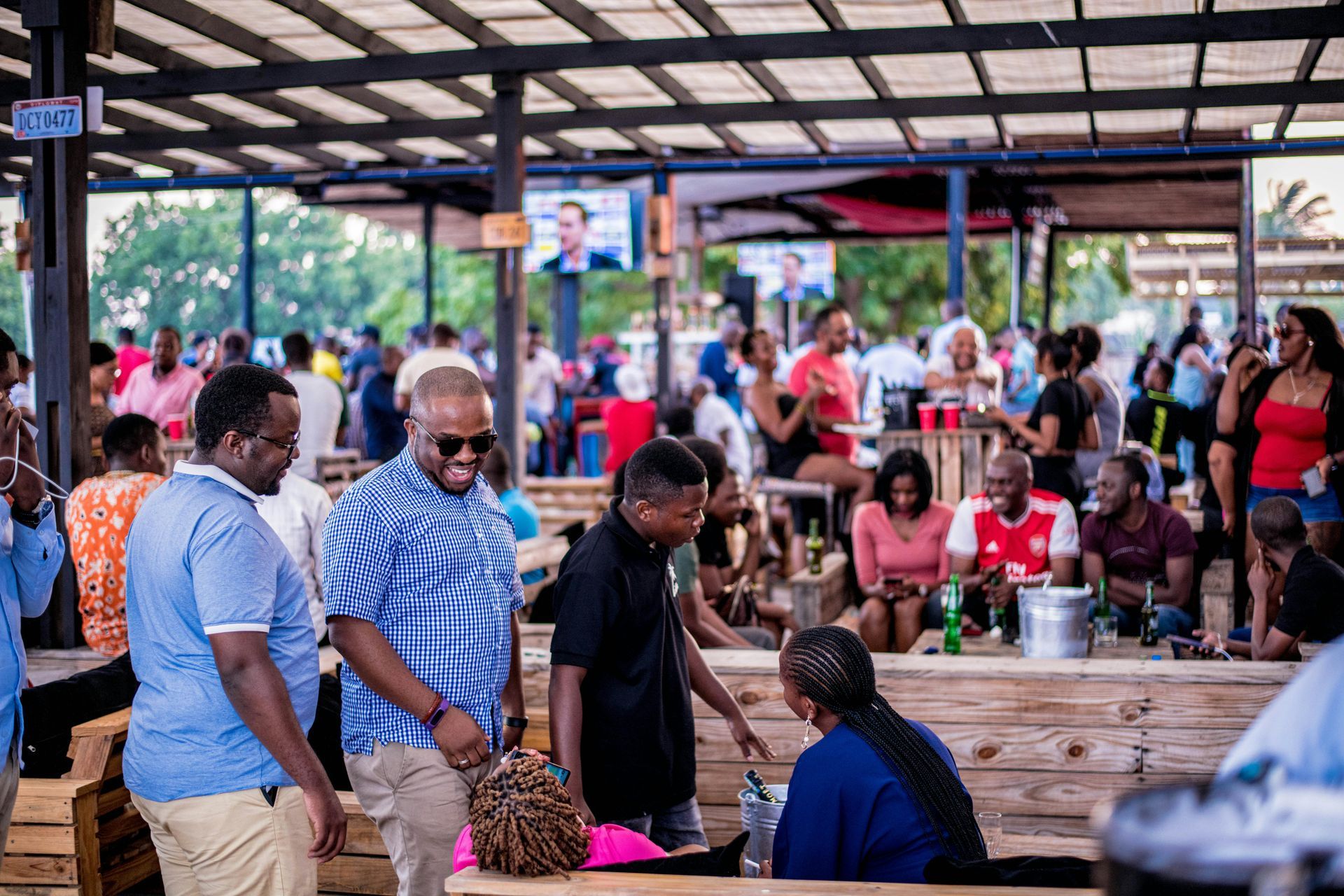 A group of people are standing around a table in a restaurant.
