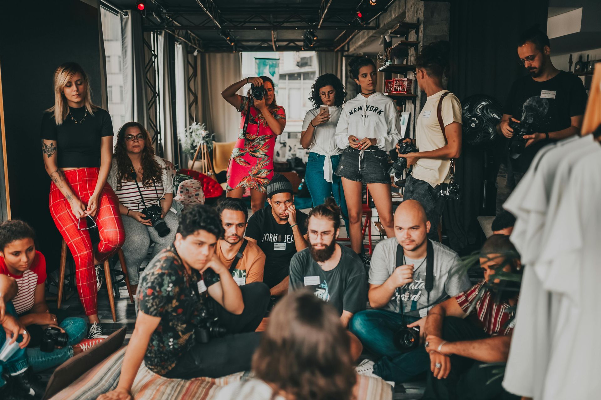 A group of people are sitting on the floor in a room.
