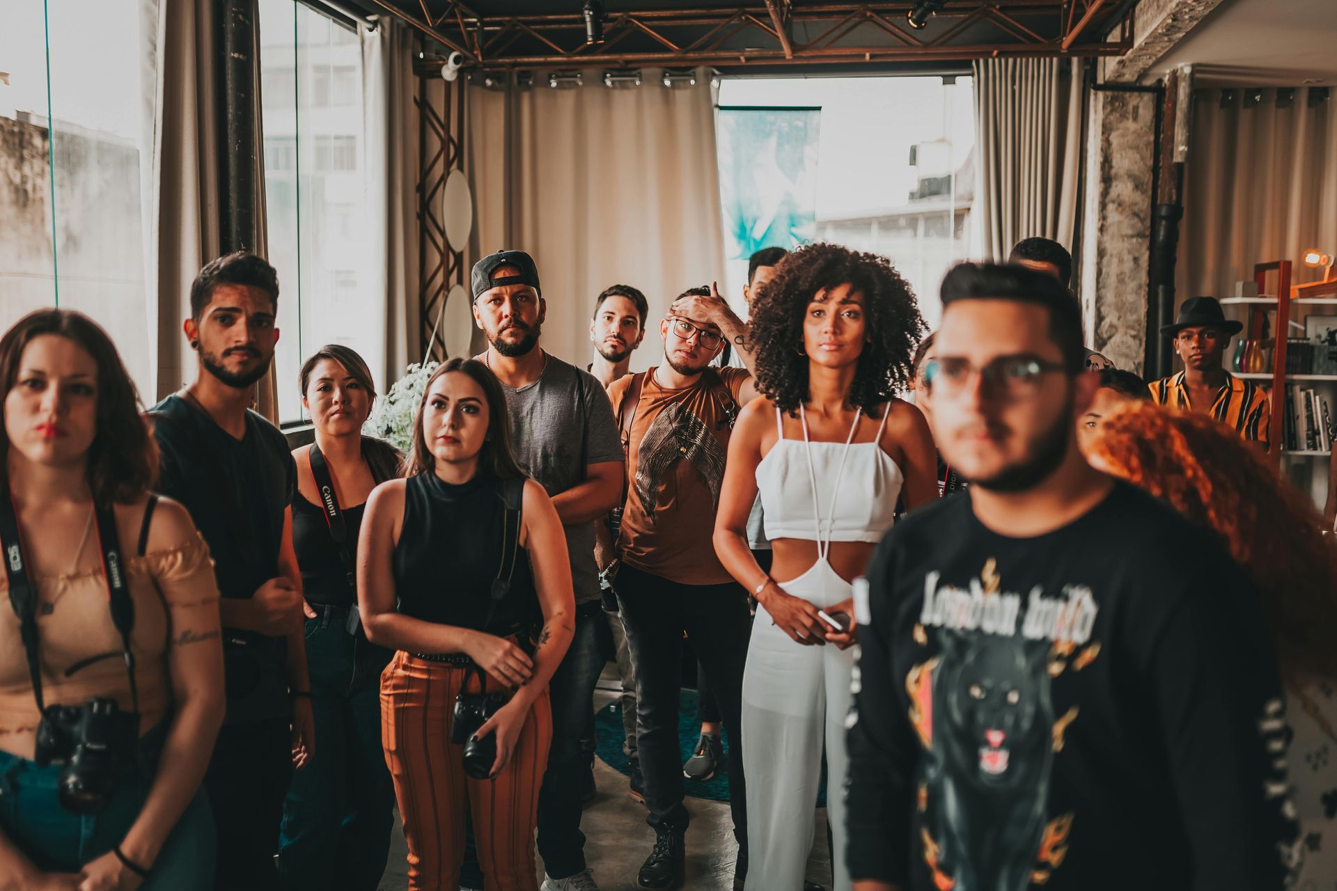 A group of people are standing in a room.