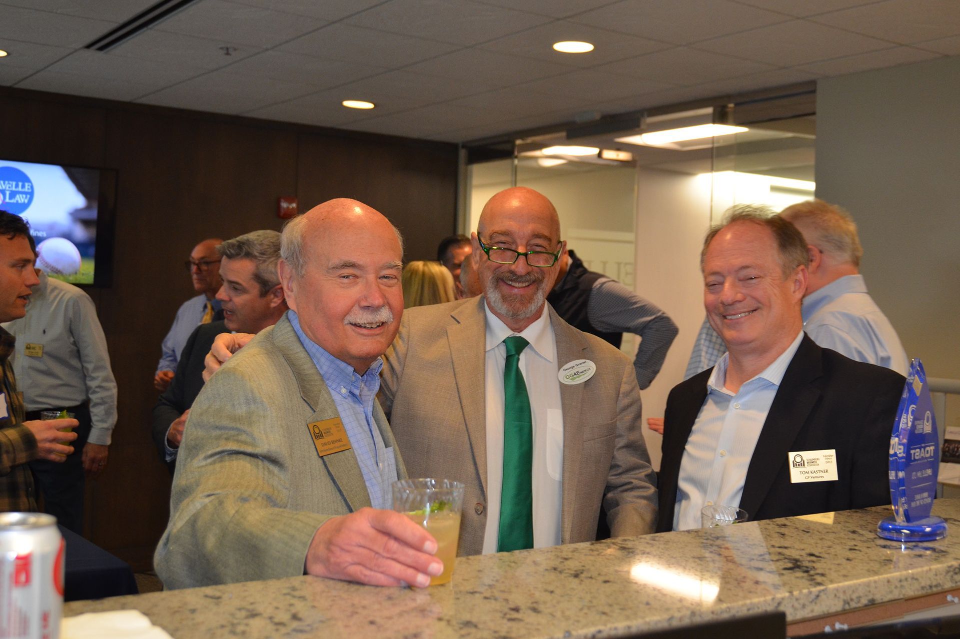 A group of men are posing for a picture at a bar