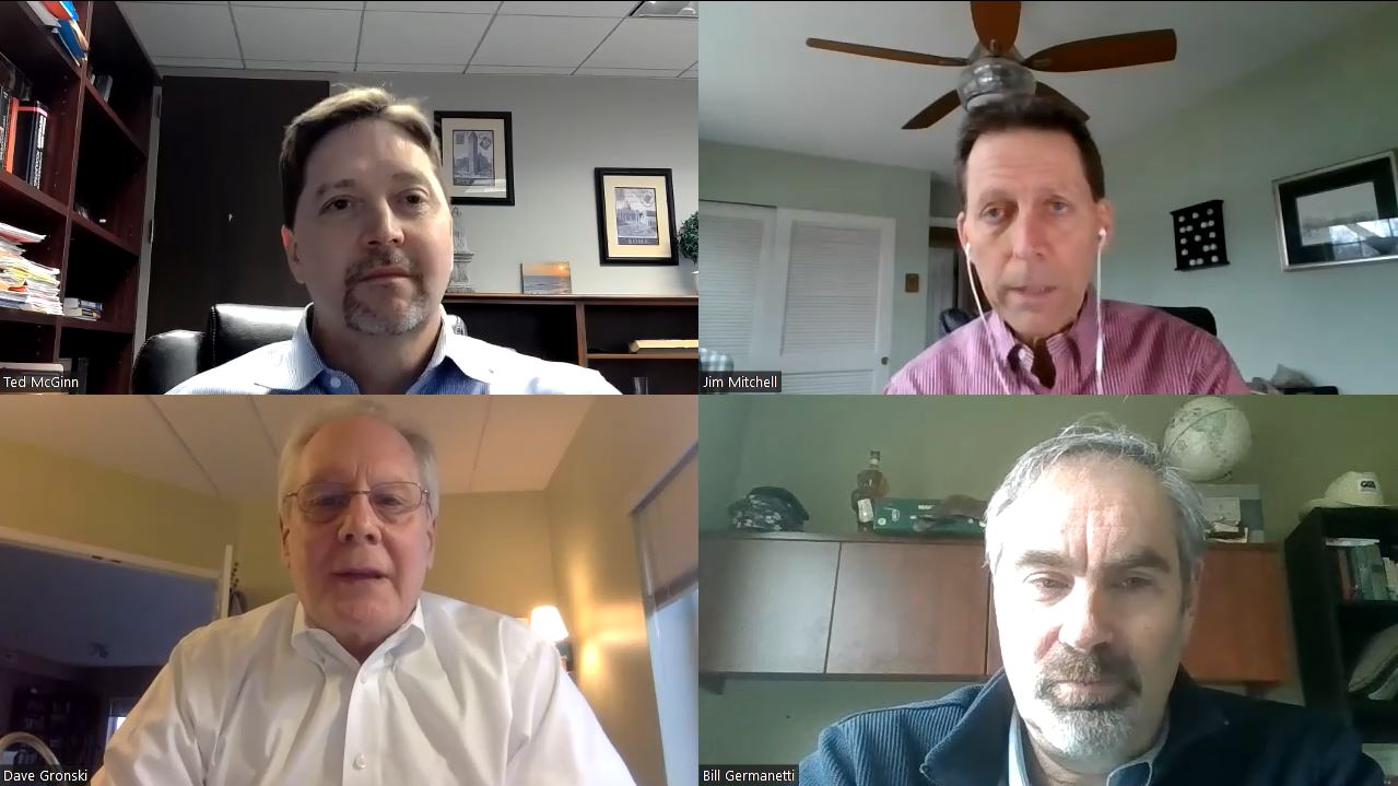 Four men are on a video call with a ceiling fan in the background.
