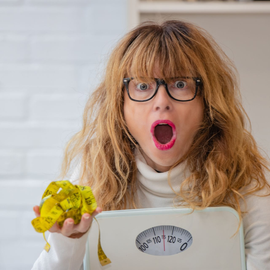 woman holding a scale
