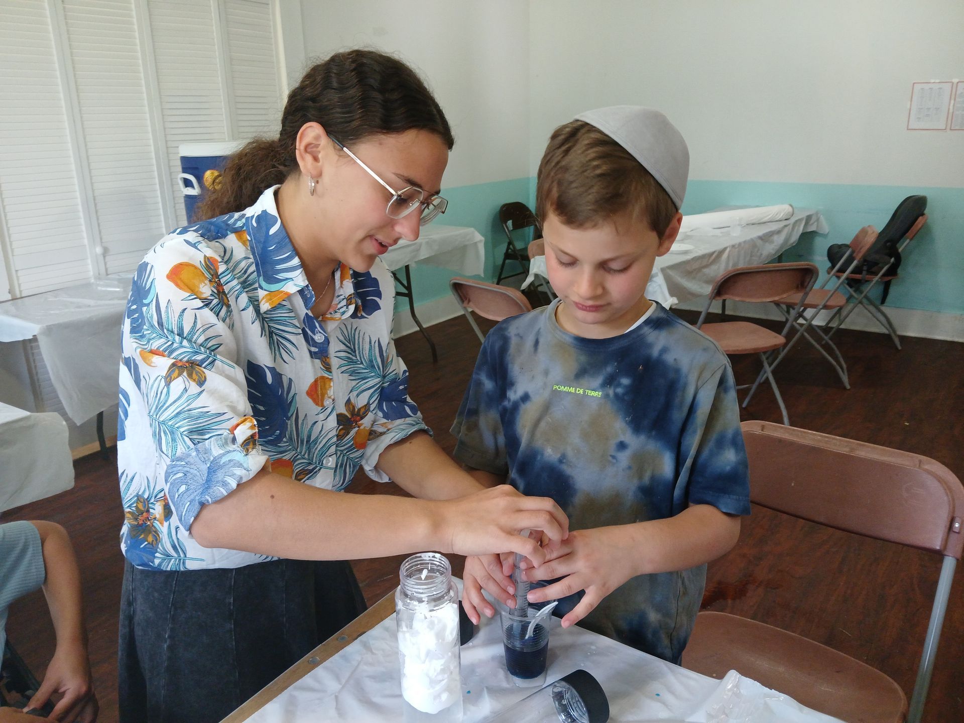A woman and a boy are working on a project together.