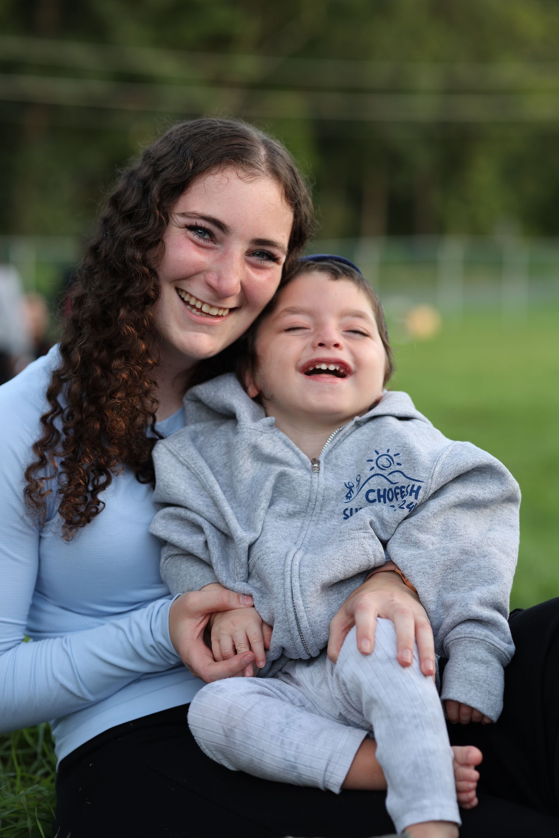 A woman is holding a little boy in her arms.