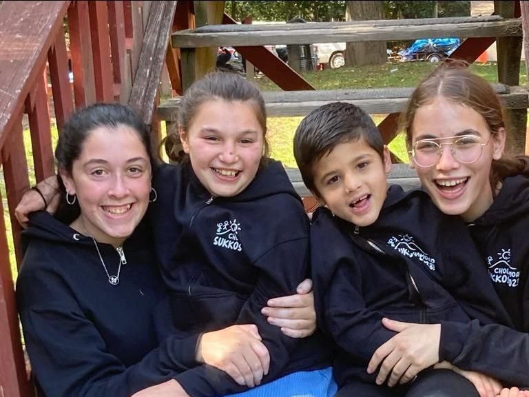 A group is posing for a picture wearing chofesh sweatshirts.