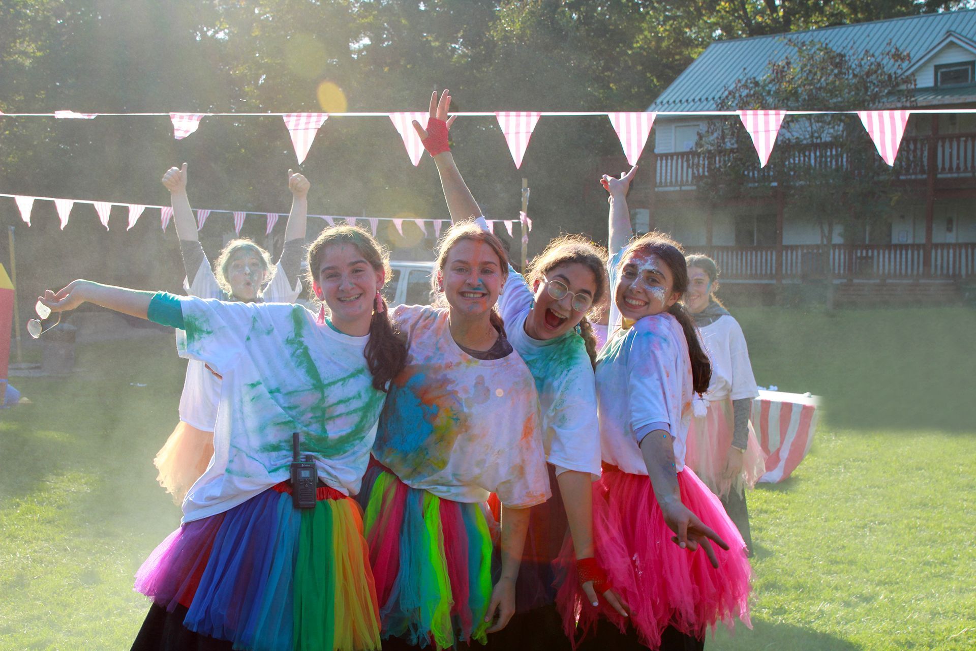 A group of girls are posing for a picture in a field.