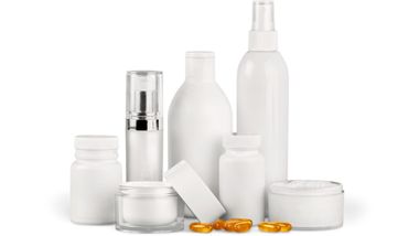 A group of white bottles , jars , and pills on a white background.