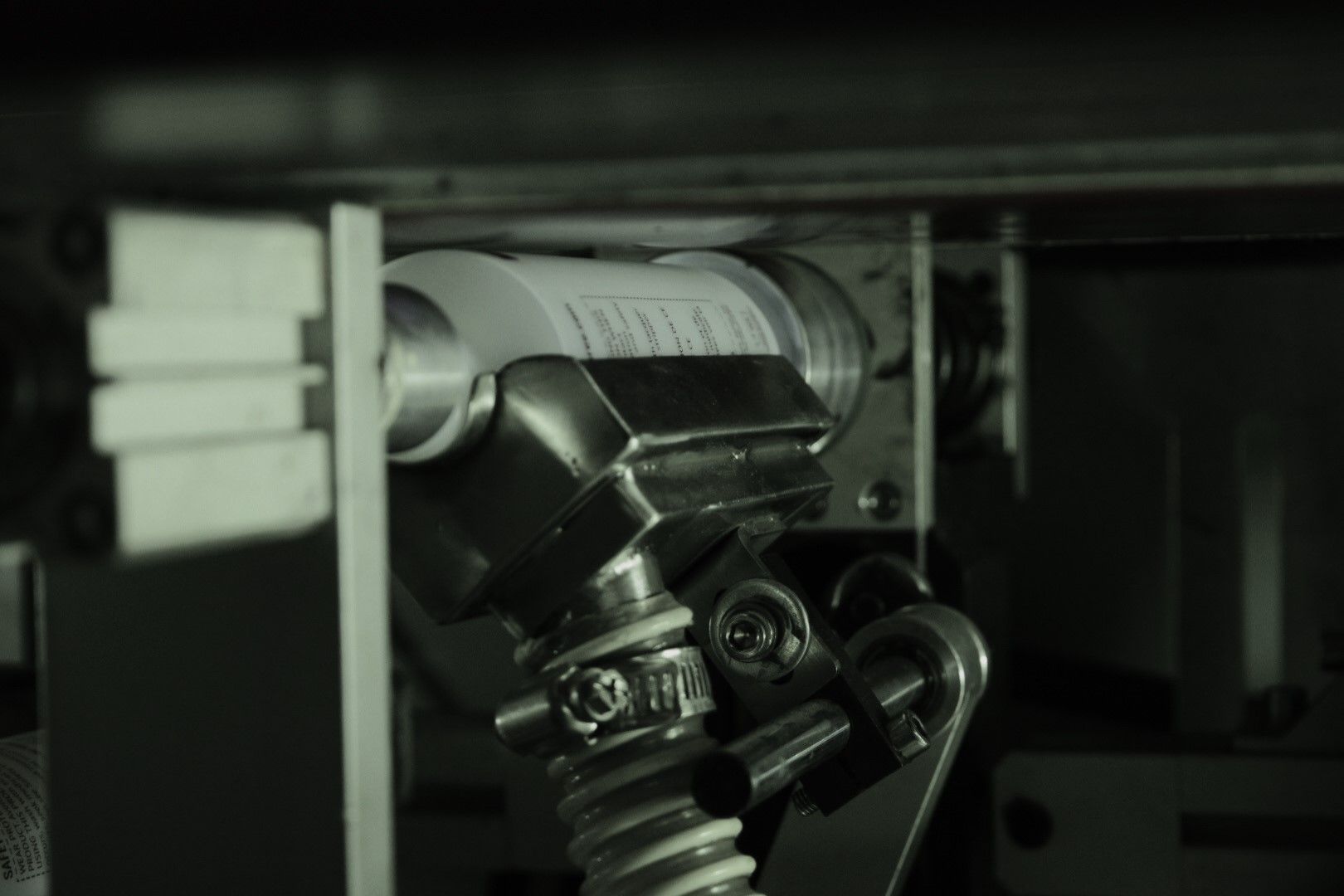 A black and white photo of a machine in a dark room.