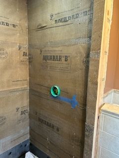 A bathroom is being remodeled and a shower is being built.