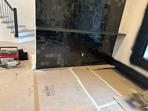 A room with a fireplace and stairs in it.