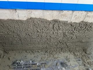 A close up of a pile of concrete on a wall.
