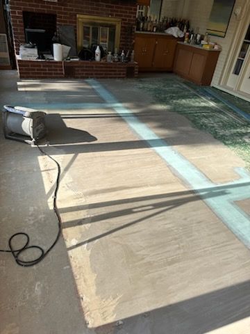 A vacuum cleaner is sitting on a wooden floor in a living room.