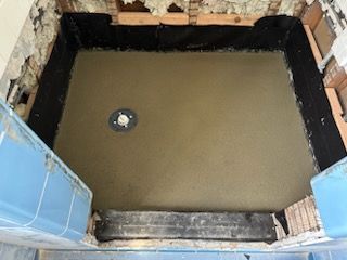 A shower stall is being built in a bathroom.