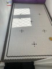 A black and white tile floor in a bathroom.