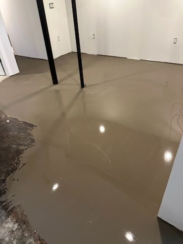 A basement with a concrete floor and white walls.