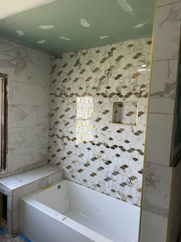 A bathroom with a bathtub and a shower under construction.